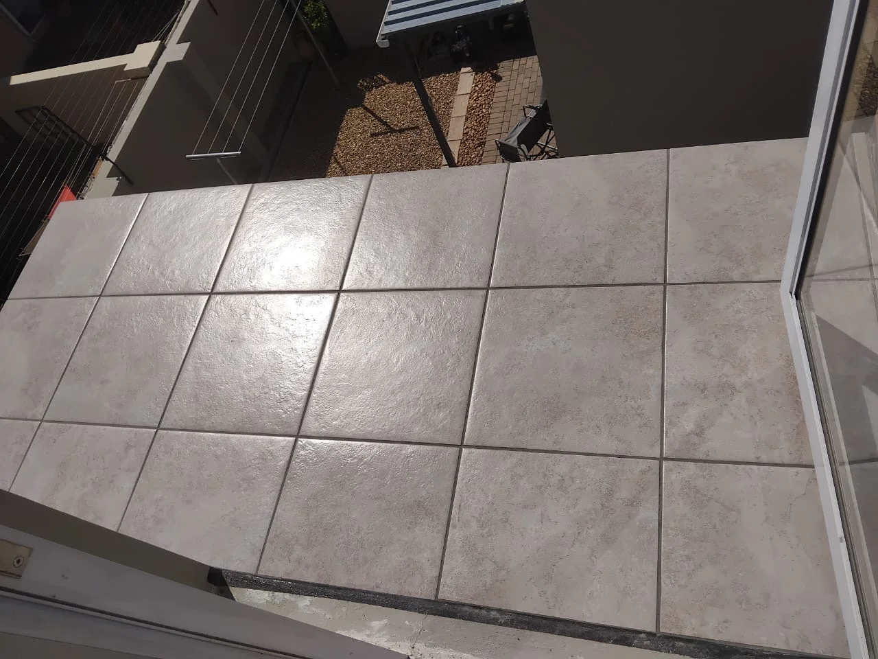 Balcony after tiling — clean stone tile finish