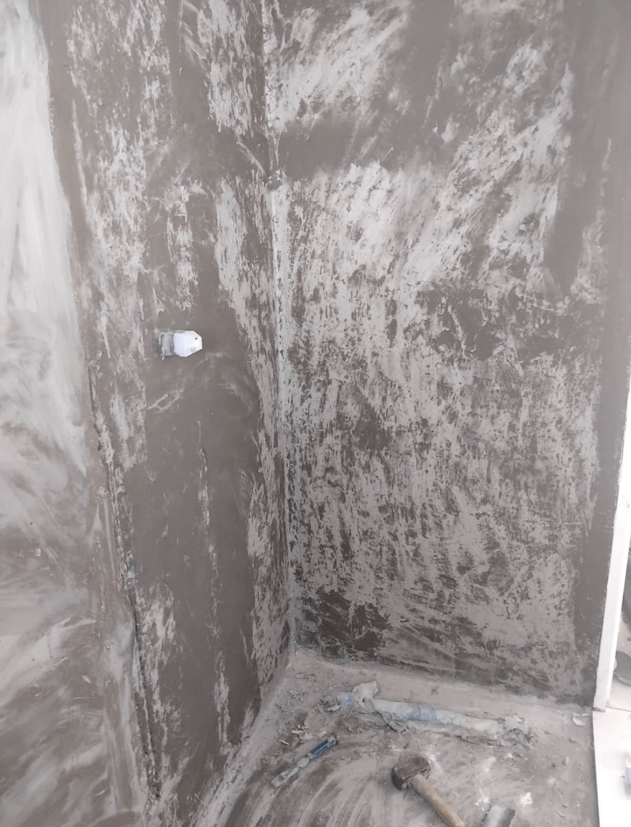 Wall before tiling — bare cement surface